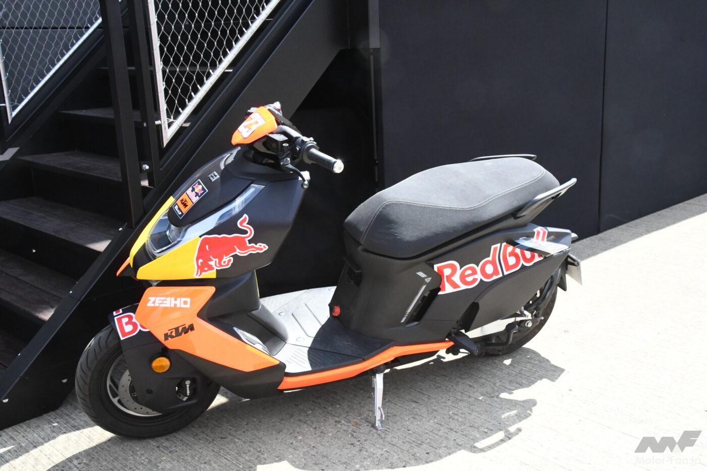 Introducing the paddock at Silverstone, the site of the British MotoGP. A row of electric scooters for transportation.